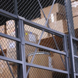 Cardboard boxes behind mesh security cage