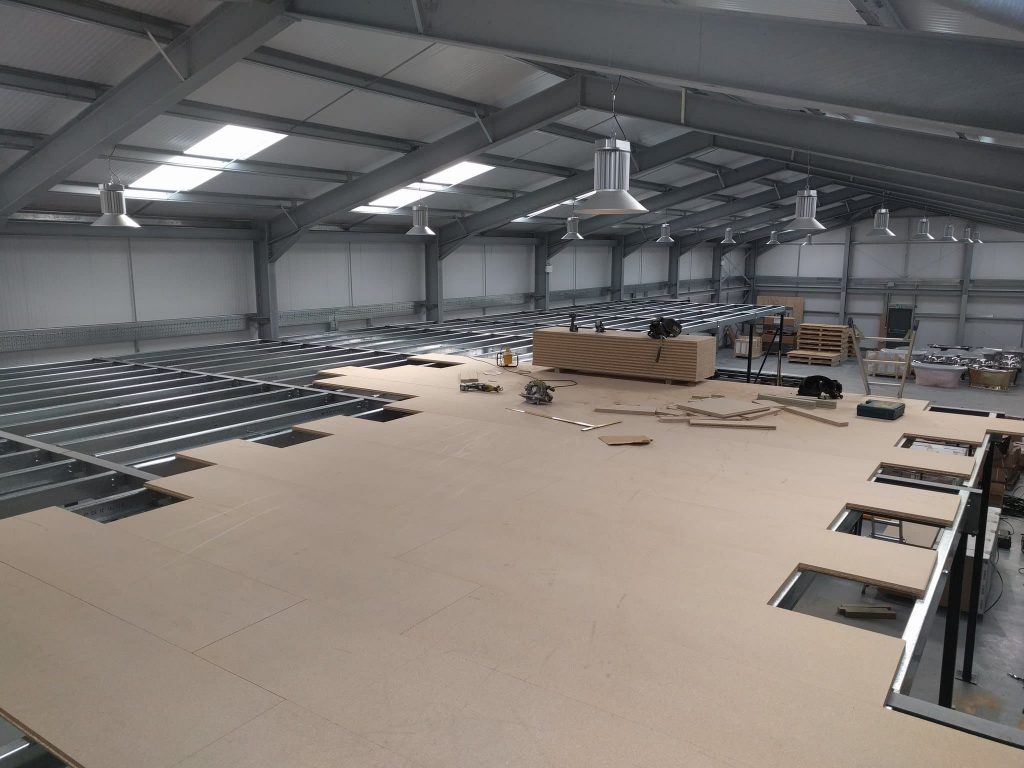 A new mezzanine floor being installed in a warehouse.